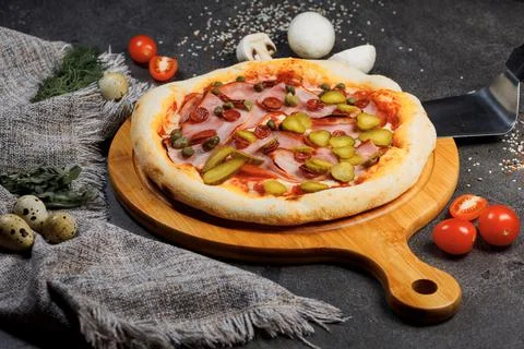 Pizza with bacon, tomatoes, cheese and olives. Italian Cuisine. Stock Photos