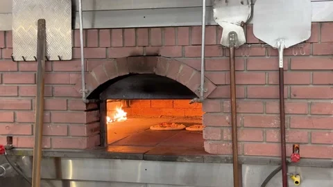 Pizza is bake cook in the hot brick traditional oven with direct fire Vidéo 229842823