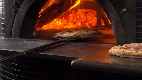 Pizza is baked in the oven with fire. Stock Footage