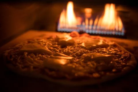 Pizza baking in an oven Stock Photos