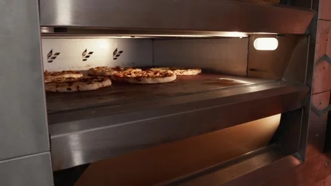 Pizza baking process in a commercial oven with multiple pizzas on the rack, Stock Footage 331755312