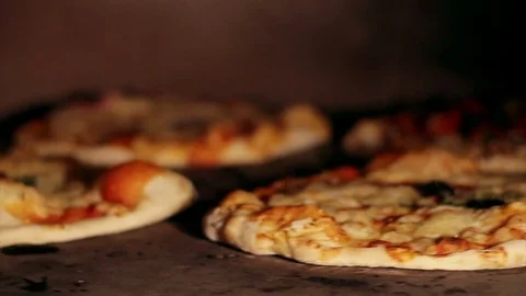 Pizza baking in wood fired stove at pizzeria (Shot D) Stock Footage