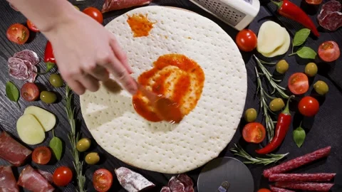 Pizza base. View from above. Smear the sauce over the pizza base. Cook at home. Stock Footage 150297865