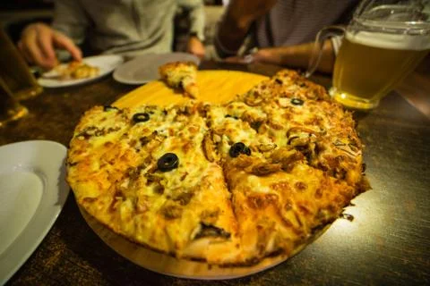 Pizza on a beer table Stock Photos