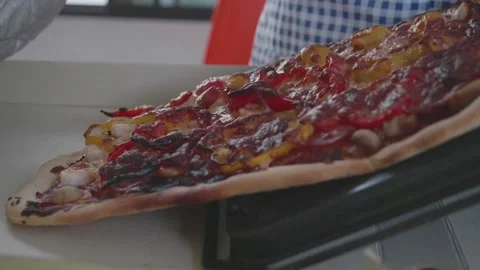 A pizza is being cooked on a pan Stock Footage 313398422