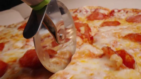 Pizza Being Cut with a Round Rolling Stainless Steel Cutter on a Wooden Table Vídeos de archivo 331100797