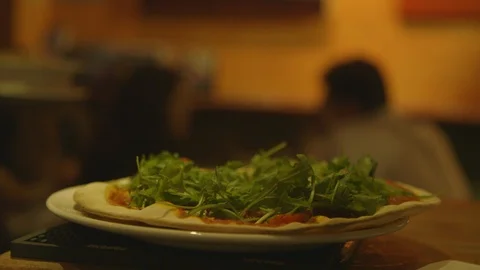 Pizza being picked up by waitresss to be served at busy London restaurant Stock-Footage 96232161