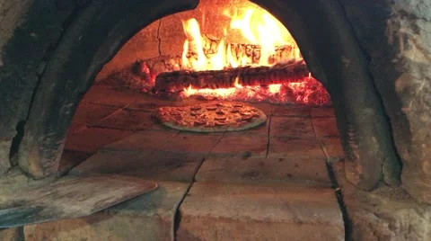 A pizza being turned in a stone oven  4K Stock Footage 59731841