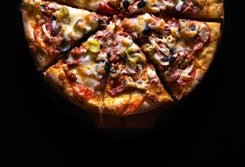 Pizza black background Stock Photos