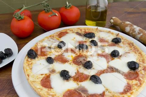 Pizza with black olives Stock Photos