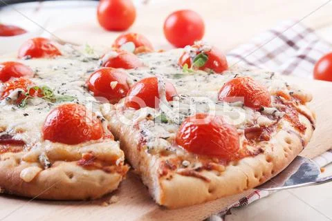 Pizza with blue cheese, ham and cherry tomatoes Stock Photos