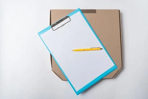 Pizza box and documents on white background top view. Food delivery to house  Foto stock
