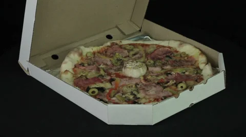 Pizza in box rotates on a black background Stock Footage 35347858