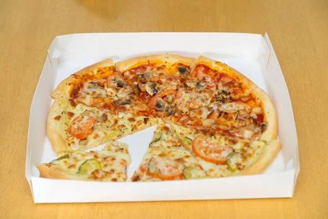 Pizza in a box on the table. Stock Photos