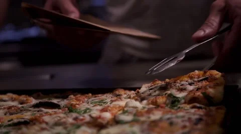 A Pizza boy picks up a slice of  Pizza Stock Footage 61560576