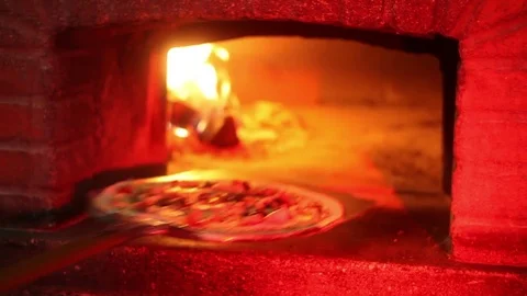 Pizza into brick oven Stock Footage 70232473
