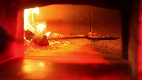 Pizza into brick oven Stock Footage 70235199