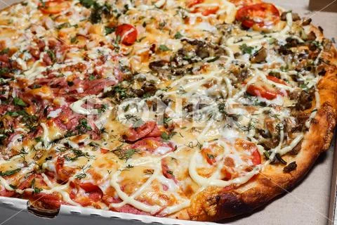 Pizza in a cardboard box. Close up. Pizza delivery. Pizza menu Stock Photos