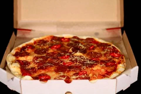 Pizza in a cardboard box Stock Photos
