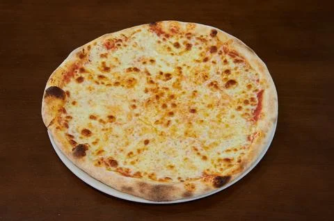A pizza with cheese on it Stock Photos