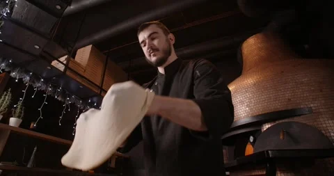 Pizza chef does dough tossing in the restaurant Stock Footage 265433870