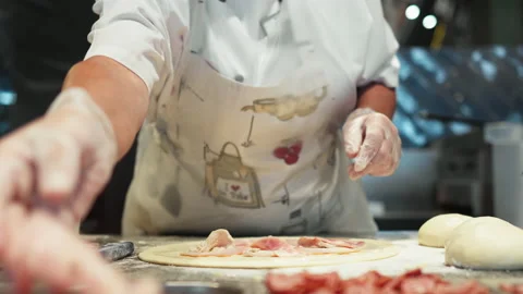 The pizza chef iola prepares the pizza dough for baking the chef puts the me Stock Footage 203892117