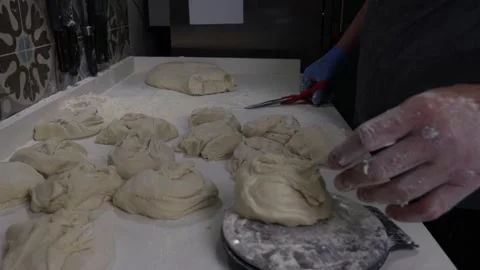 Pizza chef makes a pizza by molding the dough Stock Footage 242102722