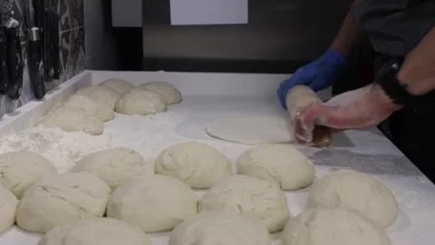 Pizza chef makes a pizza by molding the dough Stock Footage 242307896