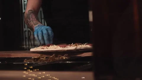 Pizza chef preparing freshly made pizza Stock Footage 197574465