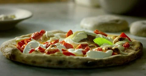 Pizza chef putting the basil on a steaming italian pizza 4k Stock Footage 87403653