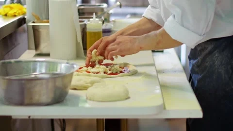 Pizza Chef Putting Mozzarella Cheese on the Raw Dough Stock Footage 288705274