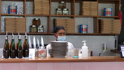 Pizza chef standing behind the counter. Bali-Indonesia-2021 Stock Footage 150878993