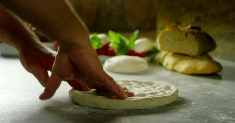 Pizza chef while kneading an Italian pizza 4k Stock Footage 87400277