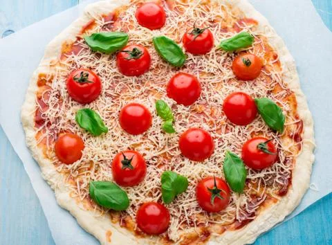 Pizza with cherry tomatoes and basil Stock Photos