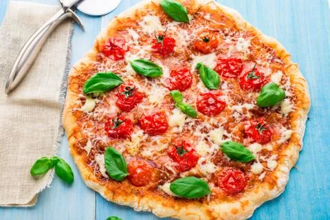 Pizza with cherry tomatoes and basil Stock Photos