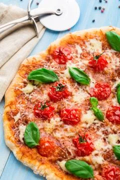 Pizza with cherry tomatoes and basil Stock Photos
