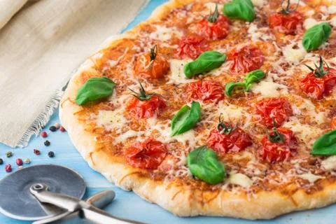 Pizza with cherry tomatoes and basil Stock Photos