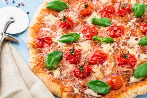 Pizza with cherry tomatoes and basil Stock Photos