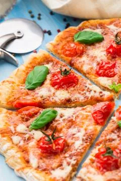 Pizza with cherry tomatoes and basil Stock Photos