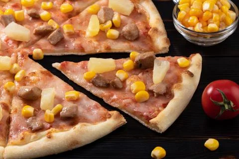 Pizza with chicken, pineapple and corn isolated on wood background Stock Photos