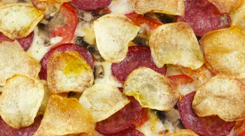 Pizza with chips and salami rotates top view Stock Footage 53578581