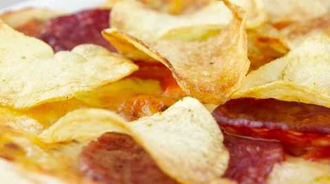 Pizza with chips and salami rotates closeup Stock Footage 53581725