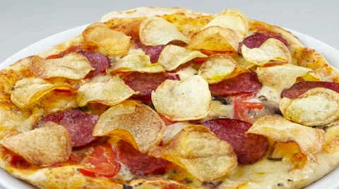 Pizza with chips and salami rotates Stock Footage 53581734