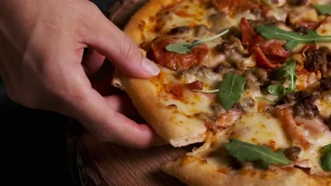 Pizza close-up with hand in frame Stock Footage 220150846