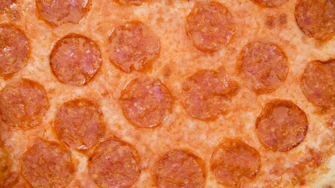 Pizza closeup top view with salami and cheese mozzarella 4k footage. Slow Stock Footage