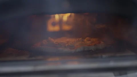 A pizza is cooking in an oven Stock Footage 297843312