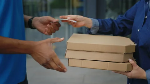 Pizza Courier. Multiethnic Courier Hands Give the Clients Her Fast Food Order Stock Footage 237466040