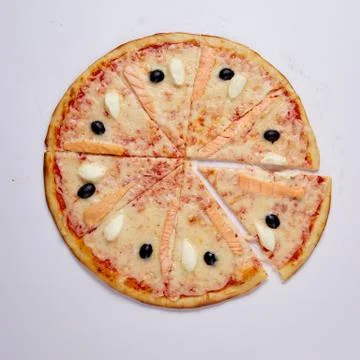 Pizza with cut off slice on a white background. Top view. Stock Photos
