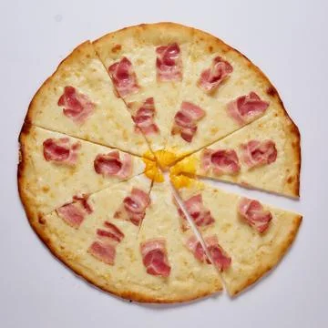 Pizza with cut off slice on a white background. Top view. Stock Photos