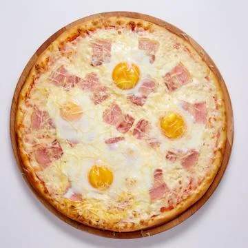 Pizza with cut off slice on a white background. Top view. Stock Photos